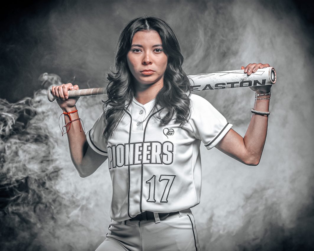 Pioneers softball player #17 holding Easton bat across shoulders in monochrome