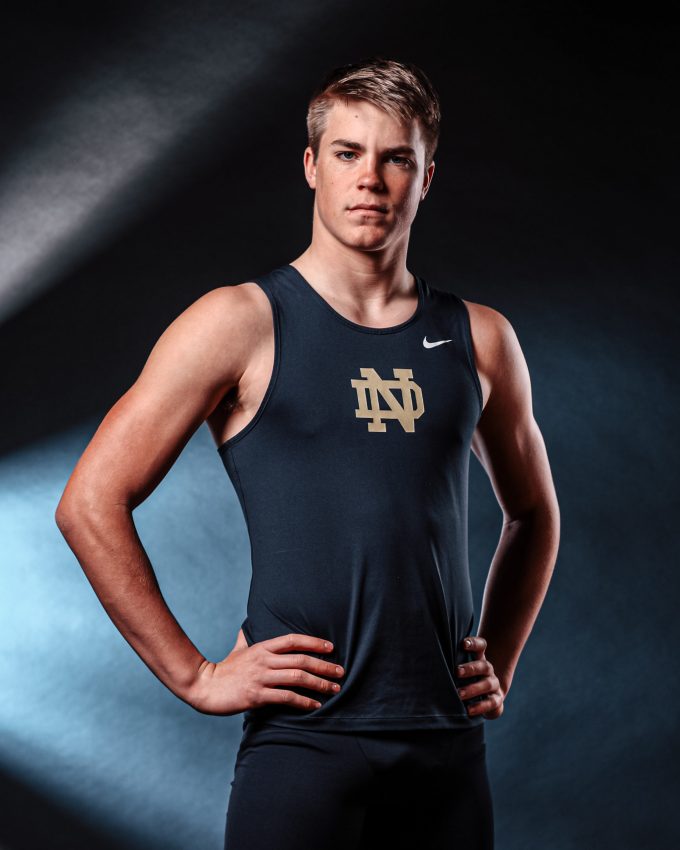 Notre Dame track athlete in Nike uniform with dramatic lighting